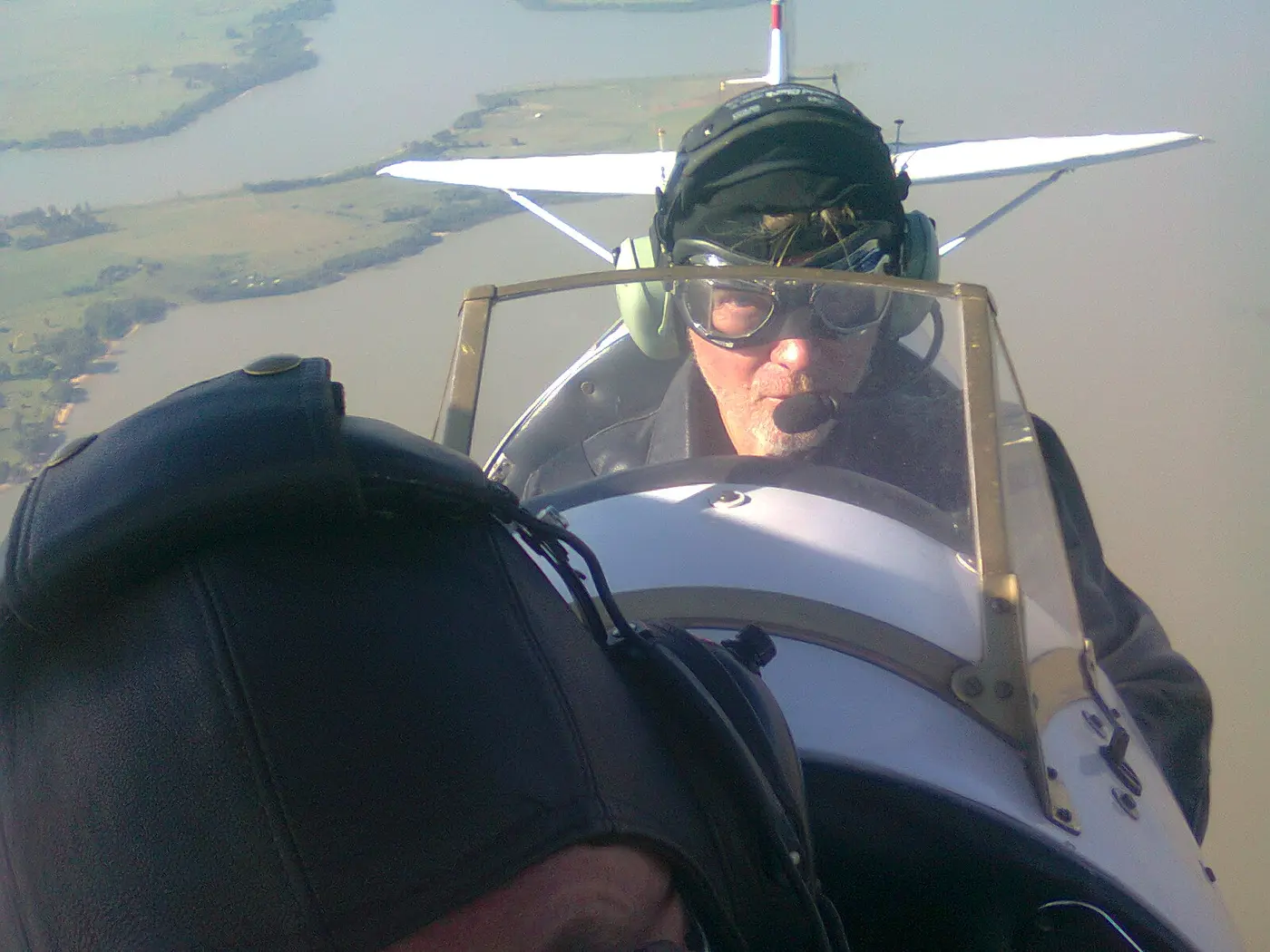 Kevin Pearman flying in an open-cockpit aircraft